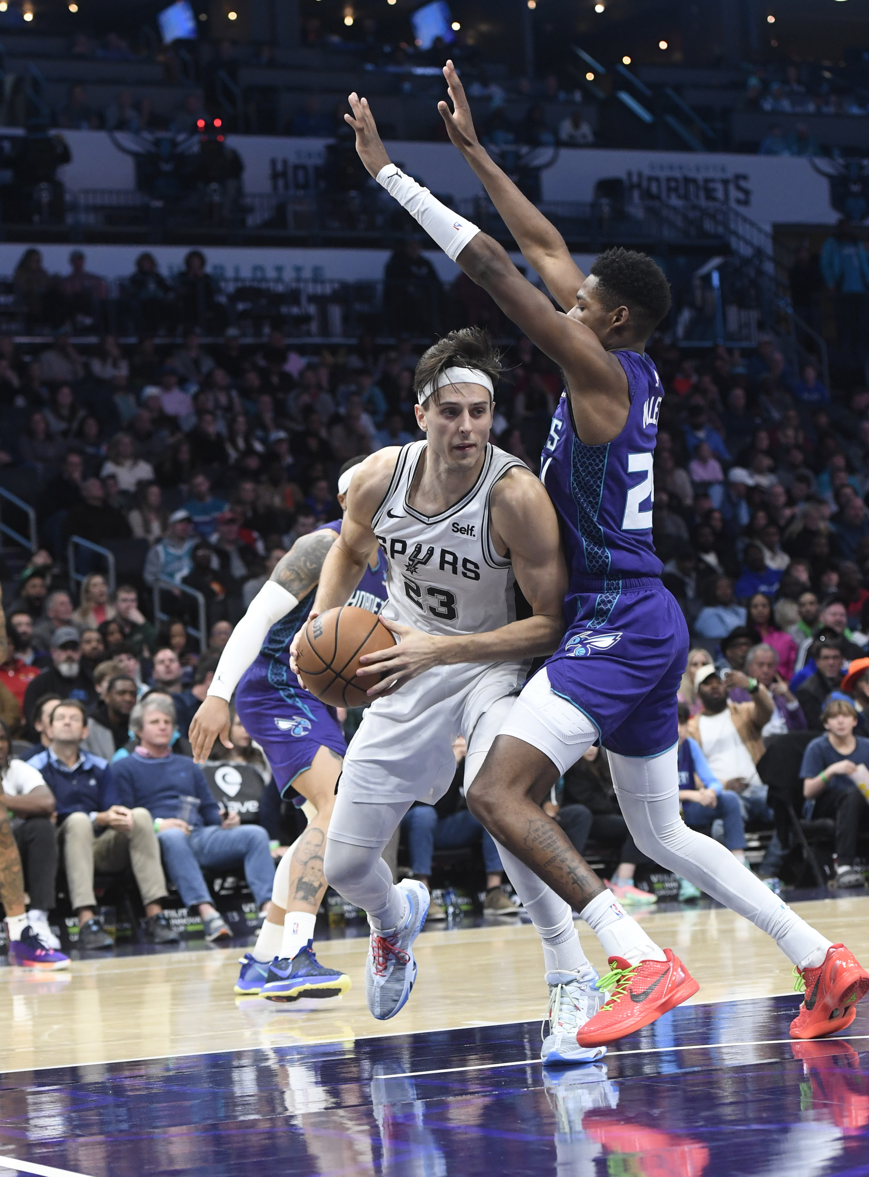 Jan 19, 2024; Charlotte, North Carolina, USA; San Antonio Spurs forward Zach Collins (23) moves past Charlotte Hornets guard forward Brandon Miller (24) during the second half at the Spectrum Center.
